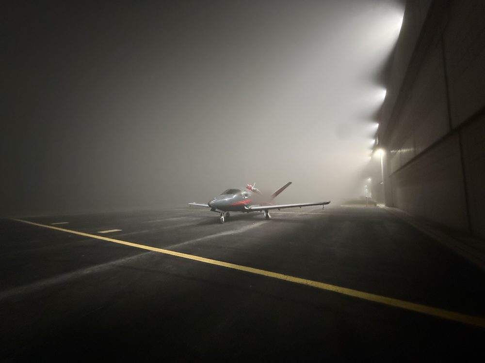 Vision Jet on a foggy ramp at night